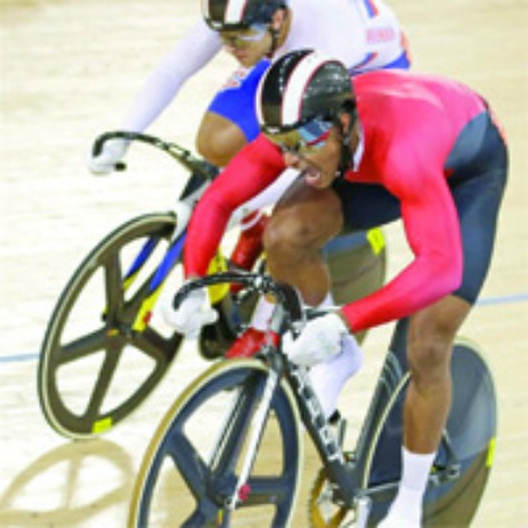 MEDAL HUNTER: T&T cyclist Njisane Phillip, bottom, sprints ahead of Russia's Denis Dmitriev during an Olympic Games men's sprint quarter-final, in London, England, yesterday. Phillip won in two straight rides, and will bid for precious metal today.